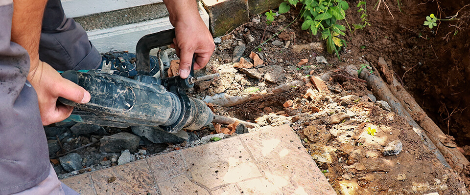 Man digging up burst pipe