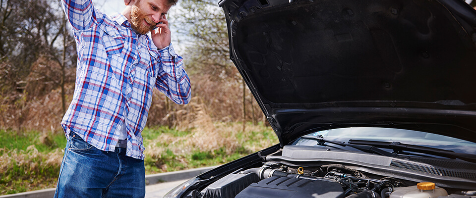 Man on phone after car breakdown